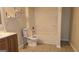 Well-lit bathroom featuring a toilet, shower, sink, and toiletries at 35 Abelia Dr, Covington, GA 30014