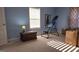 Comfortable bedroom with blue walls, a window with blinds, and a wooden chest at 35 Abelia Dr, Covington, GA 30014