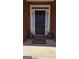 Inviting front door with sidelights, potted plants, and a 'Welcome' mat, set in a classic brick facade at 35 Abelia Dr, Covington, GA 30014
