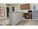 Kitchen with island, wood cabinets, and appliances at 35 Abelia Dr, Covington, GA 30014