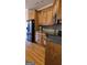Kitchen with stainless steel refrigerator, wooden cabinets and gray backsplash at 35 Abelia Dr, Covington, GA 30014