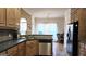 Open kitchen with stainless appliances, wood cabinets, and peninsula seating at 35 Abelia Dr, Covington, GA 30014