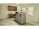 Kitchen featuring wooden cabinets, a mini-fridge, and an island with seating at 35 Abelia Dr, Covington, GA 30014