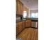 Bright kitchen featuring wood cabinets, stainless steel appliances and dark countertops at 35 Abelia Dr, Covington, GA 30014