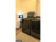 Laundry room with a new washer and dryer set, overhead cabinets, and patterned flooring at 35 Abelia Dr, Covington, GA 30014