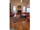 Large living room showcasing hardwood floors, a brick fireplace, comfortable seating, and ample natural light at 35 Abelia Dr, Covington, GA 30014