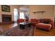 Inviting living room featuring a brick fireplace, hardwood floors, and a comfortable sectional sofa at 35 Abelia Dr, Covington, GA 30014