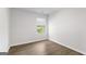 Bright bedroom featuring wood-look flooring, fresh white walls, and a window with blinds at 7262 Crestside Dr # 67, Austell, GA 30168