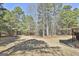 Lush backyard with mature trees providing shade and privacy to enjoy your outdoor activities at 44 Willow Leaf Way, Sharpsburg, GA 30277
