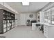 Bright finished basement with an office area, storage shelves, and neutral-toned carpet at 44 Willow Leaf Way, Sharpsburg, GA 30277