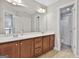 Full bathroom showcasing double vanity with wood cabinets at 44 Willow Leaf Way, Sharpsburg, GA 30277