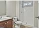 Bathroom showcasing a vanity with a sink, a toilet, and a walk-in shower with white tile at 44 Willow Leaf Way, Sharpsburg, GA 30277