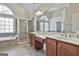 Primary bathroom featuring double vanity, walk-in shower, soaking tub, and ceramic tile flooring at 44 Willow Leaf Way, Sharpsburg, GA 30277