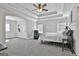 Spacious primary bedroom with tray ceiling, carpet flooring, and natural light at 44 Willow Leaf Way, Sharpsburg, GA 30277