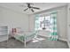 Bright bedroom showcasing large window with striped curtains and a ceiling fan at 44 Willow Leaf Way, Sharpsburg, GA 30277