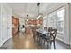 Elegant dining room adjacent to the kitchen with natural light, a modern chandelier, and hardwood floors at 44 Willow Leaf Way, Sharpsburg, GA 30277
