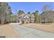 Stately brick home with a long driveway and expansive lawn, surrounded by trees at 44 Willow Leaf Way, Sharpsburg, GA 30277