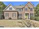 Stunning two-story brick house with a green front door, traditional shutters, and a well-maintained lawn at 44 Willow Leaf Way, Sharpsburg, GA 30277