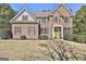Beautiful brick two-story home featuring symmetrical design, a gabled roof, and manicured front yard at 44 Willow Leaf Way, Sharpsburg, GA 30277
