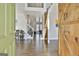 Welcoming foyer with hardwood floors, barn door, and view of the staircase at 44 Willow Leaf Way, Sharpsburg, GA 30277