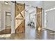 Entryway with sliding barn doors, hardwood floors, and abundant natural light at 44 Willow Leaf Way, Sharpsburg, GA 30277