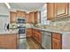 Well-equipped kitchen with stainless steel appliances, granite countertops, and stylish cabinetry at 44 Willow Leaf Way, Sharpsburg, GA 30277