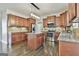 Spacious kitchen featuring granite island, stainless steel appliances, and hardwood floors at 44 Willow Leaf Way, Sharpsburg, GA 30277