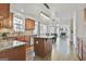 Open concept kitchen with granite countertops, island, and view into the dining and living area at 44 Willow Leaf Way, Sharpsburg, GA 30277