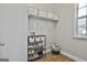 Well-organized laundry room featuring shelving and ample storage space at 44 Willow Leaf Way, Sharpsburg, GA 30277