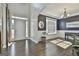 Elegant living room featuring hardwood floors, wainscoting, and a grand chandelier at 44 Willow Leaf Way, Sharpsburg, GA 30277