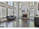Spacious living room boasts soaring ceilings, large windows, fireplace, and dark hardwood floors at 44 Willow Leaf Way, Sharpsburg, GA 30277