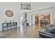Open-concept living room with soaring ceilings, hardwood floors, stairs, and decorative accents at 44 Willow Leaf Way, Sharpsburg, GA 30277