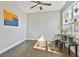 Bright living room featuring hardwood floors, artwork, ceiling fan, and large window with plants at 44 Willow Leaf Way, Sharpsburg, GA 30277