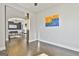 Living room leading into the dining area with hardwood floors, modern artwork, and neutral walls at 44 Willow Leaf Way, Sharpsburg, GA 30277