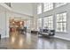 Open-concept living room showcasing tall ceilings, large windows, and hardwood floors at 44 Willow Leaf Way, Sharpsburg, GA 30277