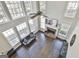 Open concept living room featuring high ceilings, a fireplace, and ample natural light at 44 Willow Leaf Way, Sharpsburg, GA 30277
