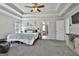 Large main bedroom with a ceiling fan and tray ceiling at 44 Willow Leaf Way, Sharpsburg, GA 30277