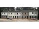 Row of townhomes with varied siding, black roofs, and construction materials nearby at 7234 Crestside Dr # 81, Austell, GA 30168