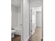 The hallway leads to the bath with wood-look flooring, a tub, and a neutral palette at 7234 Crestside Dr # 81, Austell, GA 30168