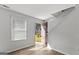 Bright living room with hardwood floors, white walls, open door, and staircase at 7234 Crestside Dr # 81, Austell, GA 30168