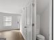 Hallway showcasing natural light, a half bath, and a staircase at 7236 Crestside Dr # 80, Austell, GA 30168