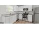 Modern kitchen with stainless steel appliances, granite countertops and all white cabinetry at 7236 Crestside Dr # 80, Austell, GA 30168