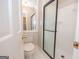 Compact bathroom with a tile shower, toilet, and storage at 201 Lanyard Loop, Peachtree City, GA 30269