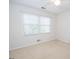 Empty bedroom featuring natural light and neutral carpet at 201 Lanyard Loop, Peachtree City, GA 30269