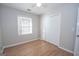 Clean, minimalistic bedroom featuring wood floors, a window, and a closet at 201 Lanyard Loop, Peachtree City, GA 30269