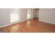 Spacious bedroom featuring hardwood floors, neutral walls, and large windows to allow natural light to flow into the space at 201 Lanyard Loop, Peachtree City, GA 30269