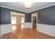View of the dining room with hardwood floors and white trim, leading to the living room and kitchen at 201 Lanyard Loop, Peachtree City, GA 30269