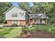 Charming two-story home with a combination of light blue siding and red brick exterior, complemented by a well-manicured front yard at 201 Lanyard Loop, Peachtree City, GA 30269