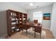 Functional home office with a large wooden desk, shelving, and natural light at 201 Lanyard Loop, Peachtree City, GA 30269