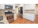 A well designed kitchen with stainless steel appliances, granite countertops, and white cabinets offer style and practicality at 201 Lanyard Loop, Peachtree City, GA 30269